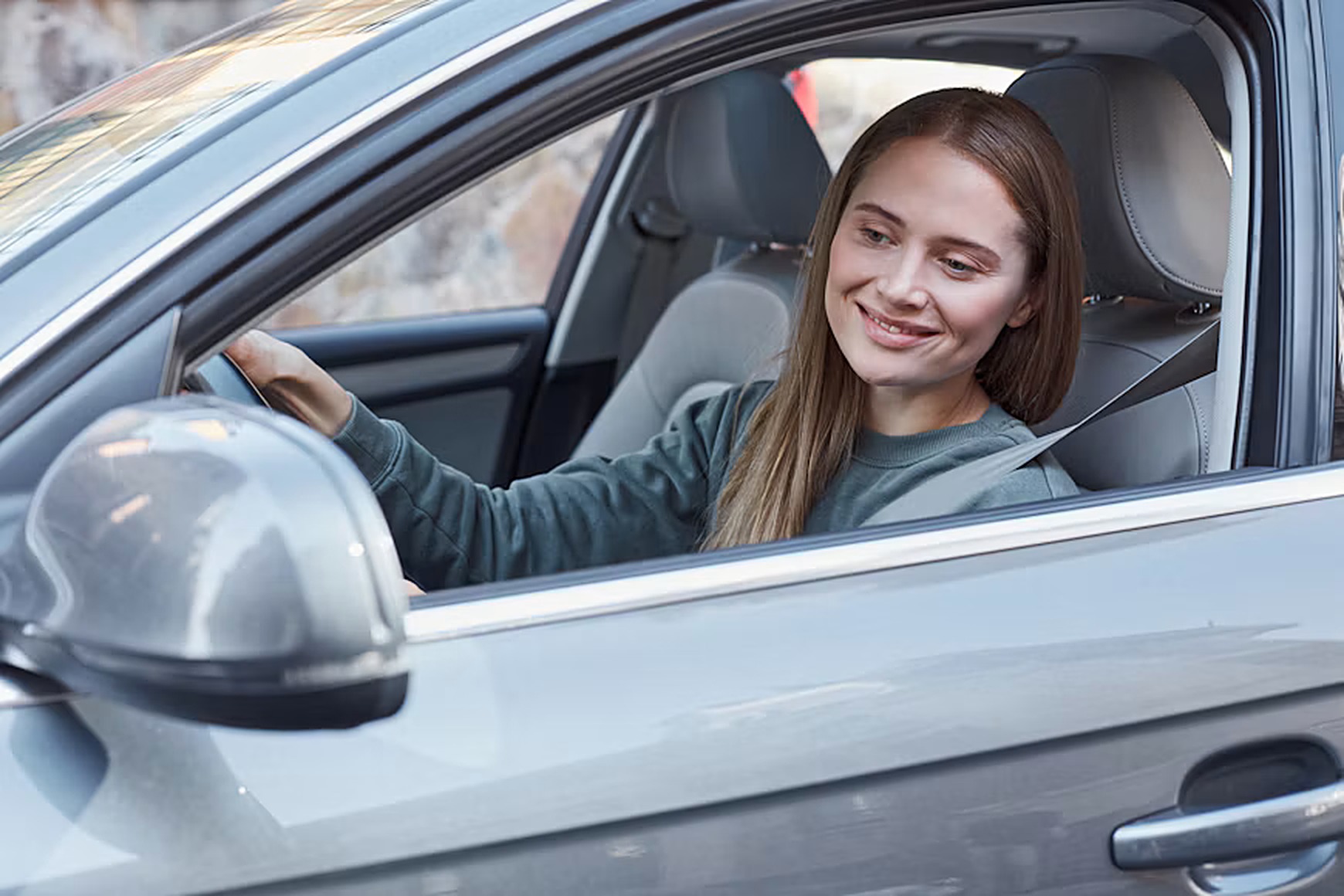 A university student sharing a car ride with a fellow student on the way to campus